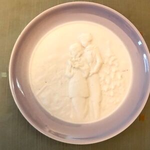 Lladro 4” plate with raised couple depicted.